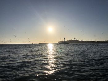 Scenic view of sea against sky at sunset
