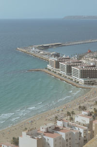 High angle view of sea and buildings against sky