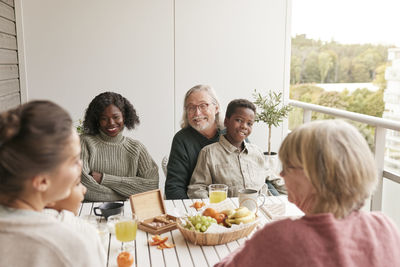 Family sitting at table on balcony