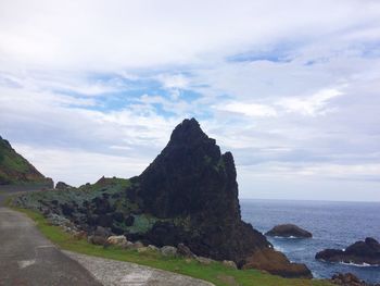 Scenic view of sea against cloudy sky