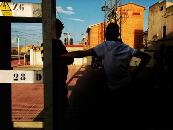 Man standing in city against sky