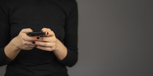 Midsection of man using mobile phone