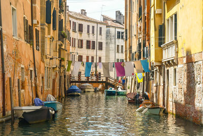 Picturesque venetian canal with cloths hanging between the houses to dry, venice, italy
