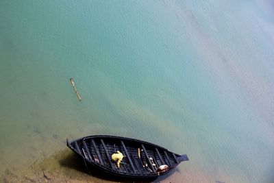 High angle view of fishermen in boat moored at shore