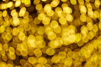 Glittering stars of bokeh. yellow shining sparkles for celebrate. black background