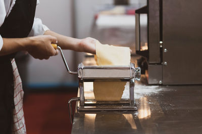 Midsection of man preparing food in kitchen