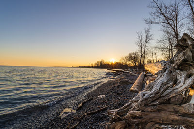 Scenic view of sea against clear sky during sunset