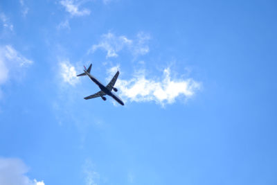 Low angle view of airplane flying in sky