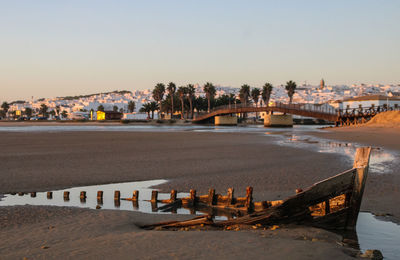 Scenic view of sea and buildings against clear sky