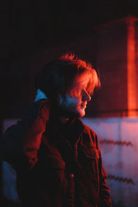 Side view of woman looking at night