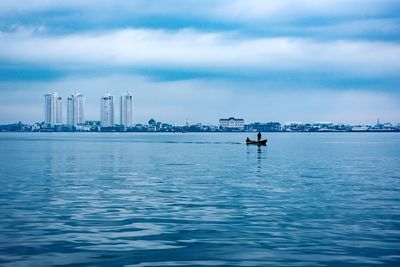 Scenic view of sea against sky in city