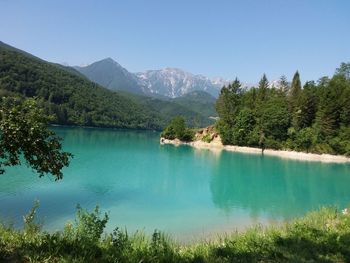 Scenic view of lake and mountains against clear sky