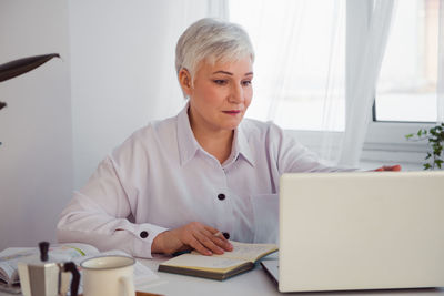 Businesswoman working on laptop in office