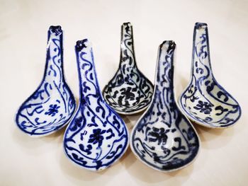 High angle view of patterned spoons on table