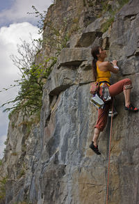 Female climber on a difficult climb in the wye valley / south wales