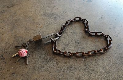 Close-up of padlock on rusty chain