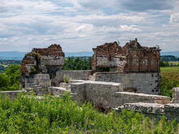 Old ruins on field against sky