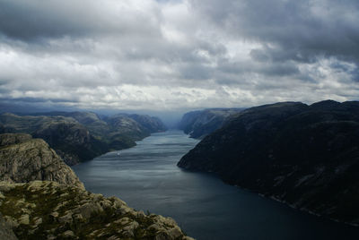 Scenic view of sea and mountains against sky