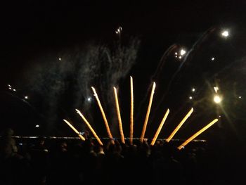 Low angle view of firework display at night