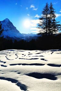 Scenic view of snow covered mountains against sky