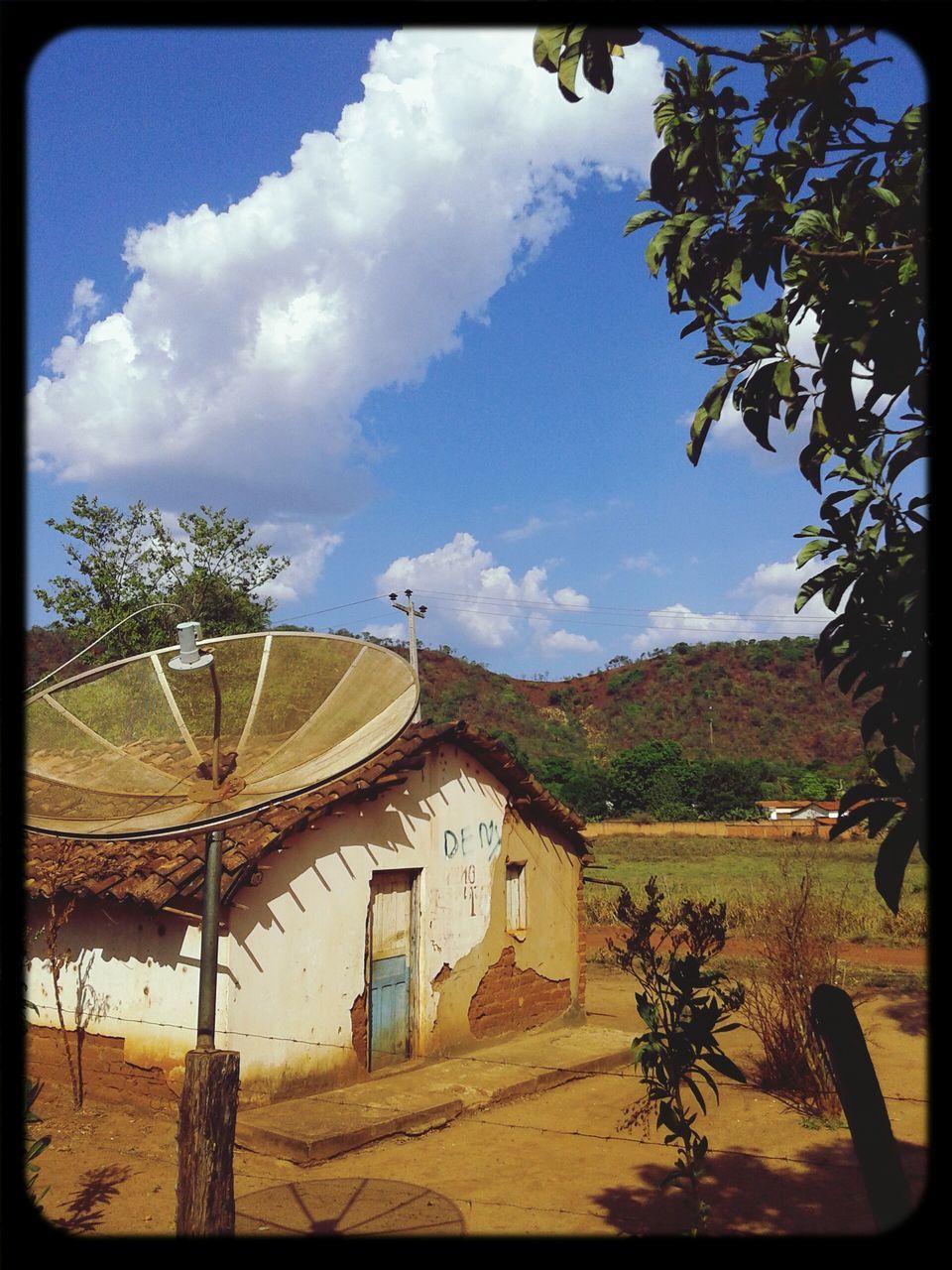 transfer print, sky, built structure, architecture, tree, building exterior, auto post production filter, cloud - sky, cloud, house, landscape, field, day, outdoors, rural scene, sunlight, nature, tranquility, no people, tranquil scene