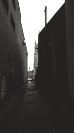 Street amidst buildings against clear sky