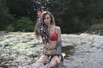 Young woman standing in water