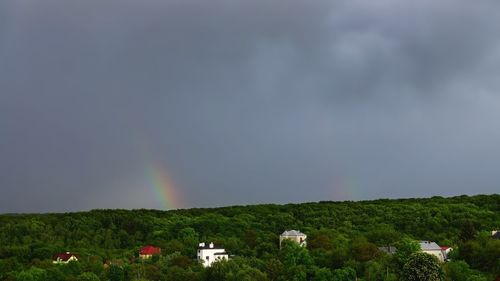 Scenic view of field against rainbow in sky