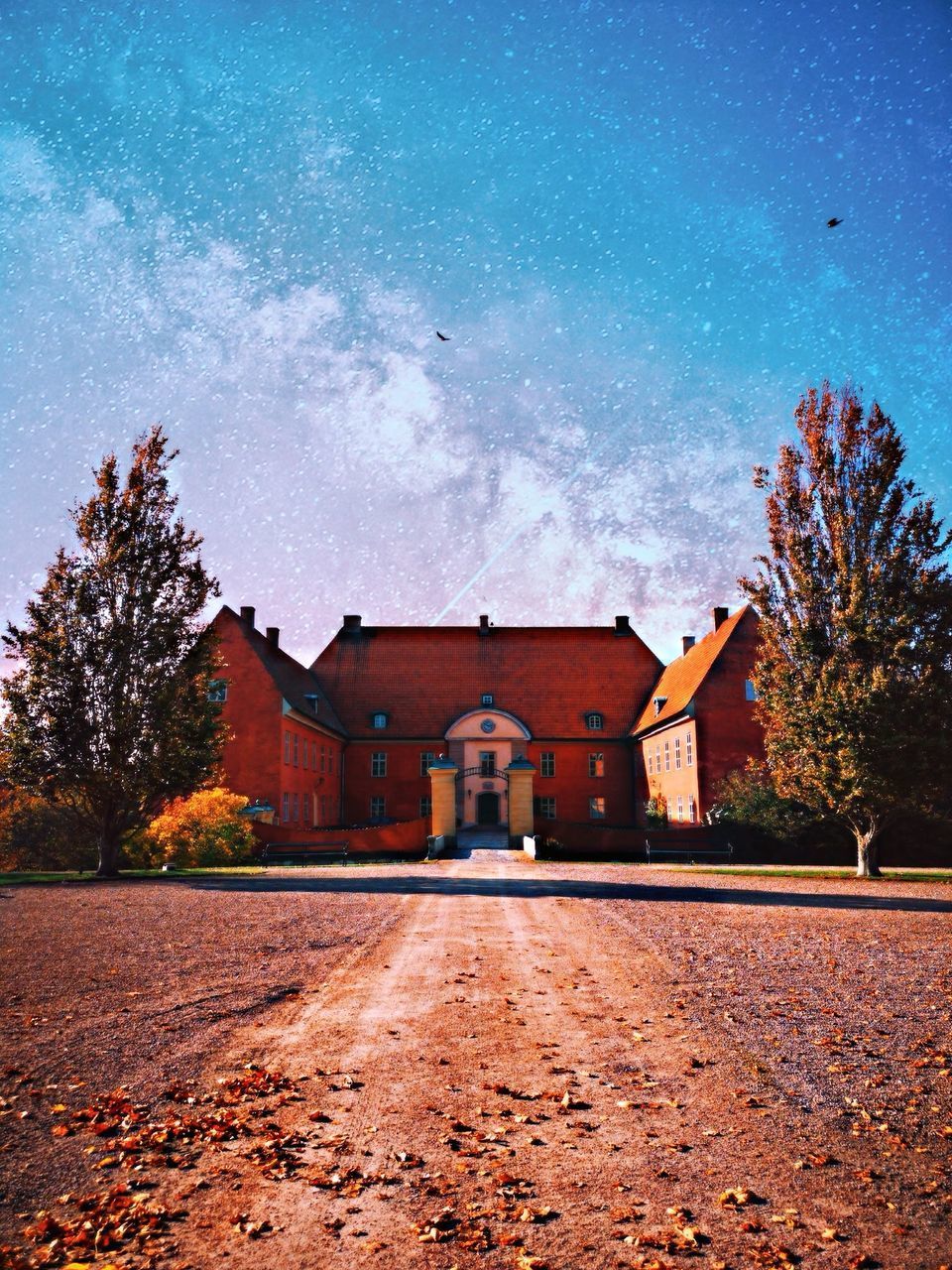 ROAD AMIDST BUILDINGS AGAINST SKY