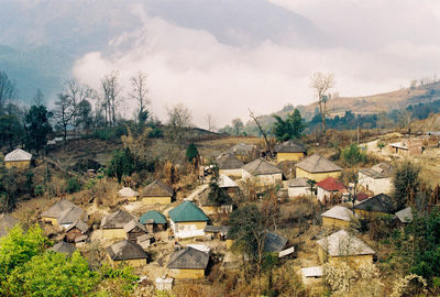 High angle view of houses in town against sky