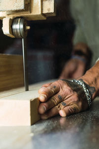 Close-up of man working on wood