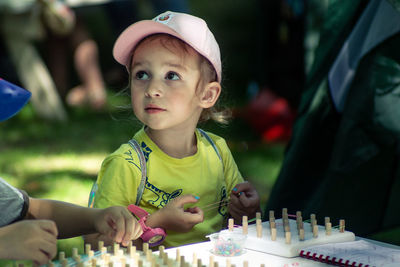 Portrait of cute girl playing on table