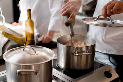 Midsection of man preparing food in kitchen