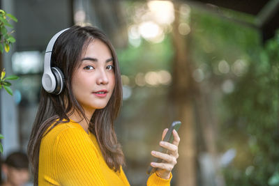 Portrait of young woman using smart phone outdoors