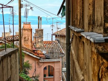 Buildings against sky seen through balcony