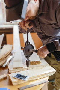 Carpenter working at workbench in workshop