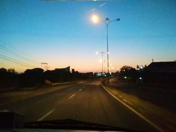 Cars on street seen through windshield