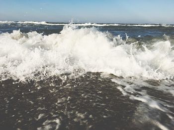 Waves breaking against sea