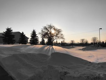 Snow covered landscape against clear sky