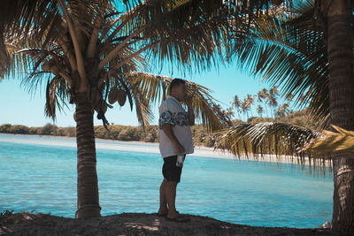 Rear view of woman standing on beach