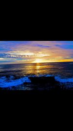 Scenic view of sea against sky at sunset