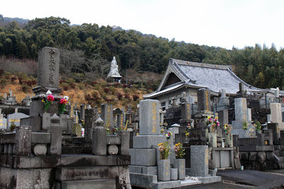 View of cemetery and buildings against sky