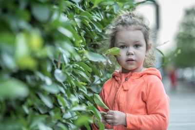 Portrait of cute girl standing outdoors