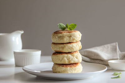 Sweet cheese pancakes with honey on a white plate. homemade recipe cheesecakes.