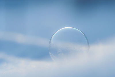 Close-up of bubbles against sky