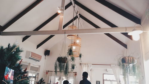 Low angle view of birdcage hanging on ceiling