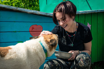 Dog at the shelter.  lonely dogs in cage with cheerful woman volunteer