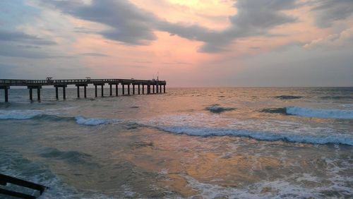 Scenic view of beach against sky during sunset