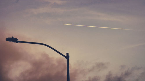 Low angle view of silhouette street light against sky