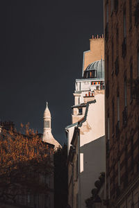 Low angle view of buildings against sky in city